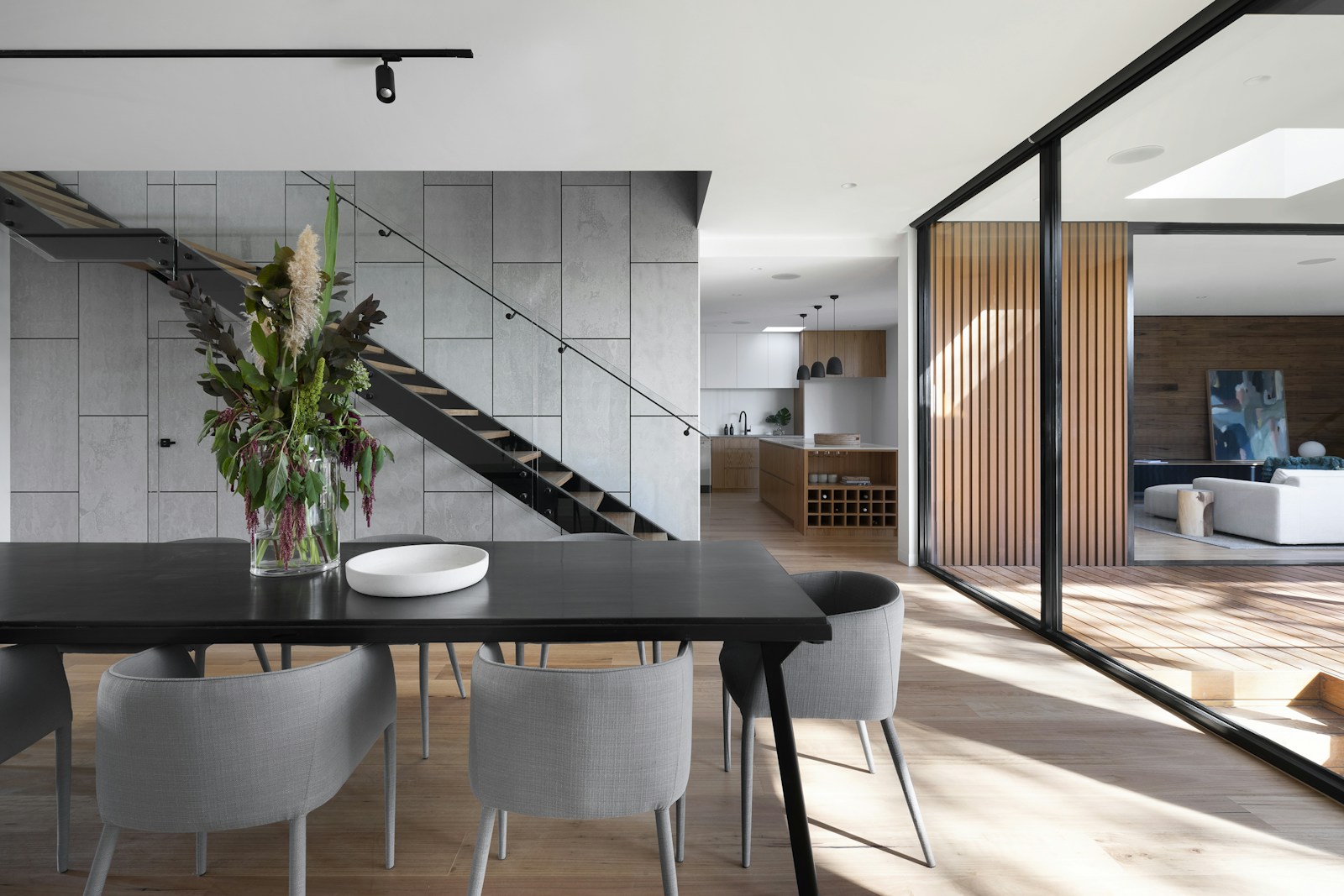 Bright open-plan architectural interior with a refined kitchen and dining area